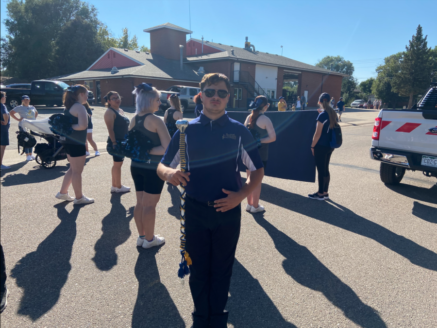 Levi Mays, senior at Frederick High and Drum Major in the Marching Band, prepares to lead the band through the parade at the Town Of Fredericks Miners Day Celebration. “I would say [serving as Drum Major] has [helped me prepare to pursue my post-secondary plans because] it has definitely improved my leadership skills, and it’s definitely taught me how to handle people when I am in that role of a leader,” Levi Mays says.