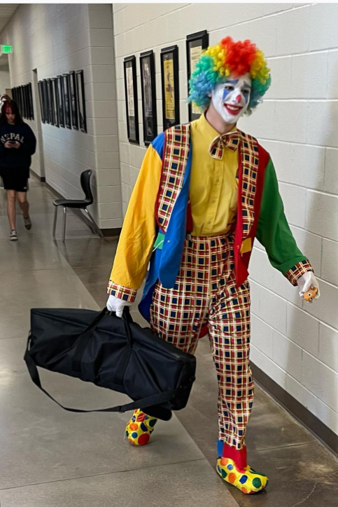 Thomas Beeker as Grombo the Clown carries a filming tripod down the C hallway on Tuesday while behind him students stare. As Thomas walked down hallways and into classrooms, he caused some students with a fear of clowns to panic. I wish my students had thought this through a little bit more, Frederick Film adviser Mr. Coon told us. Their film has jokes about people who are afraid of clowns, so they shouldnt be surprised when people freak out when seeing them work on their film.