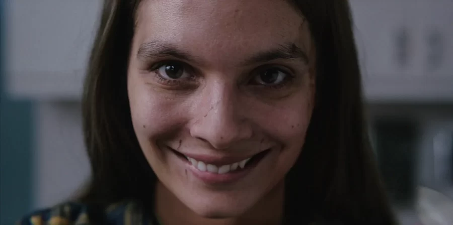 Actress+Caitlin+Stasey+embodies+the+creepy+grin+of+the+title+villain+in+Smile.+Despite+a+basic+sounding+premise--a+killer+smile+is+on+the+loose--the+film+has+ruled+the+box+office+and+has+positive+reviews.+Ultimately%2C+it+has+some+effective+scares+but+is+bogged+down+by+a+complicated+and+unsatisfying+ending.