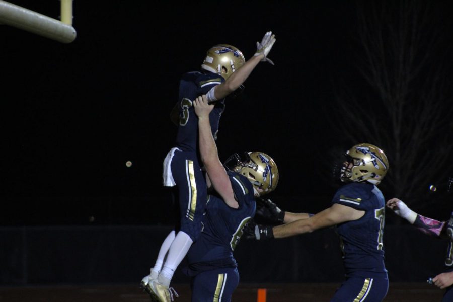 Jackson Ramer lifts up Parker Ayres in celebration of his touchdown. 