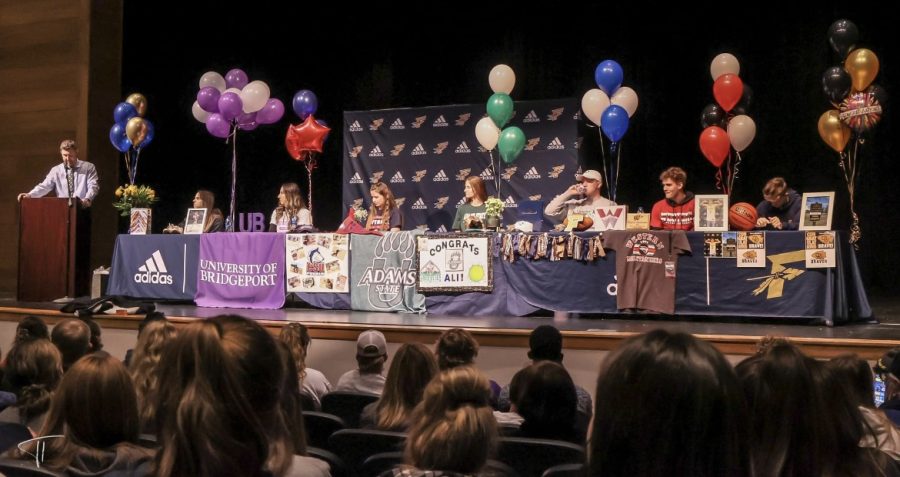 Bella Hewitt, Ali Davis, Bryce Conover, Brooklyn Weingaedt, Jacoby Conway, Alex Sturn, and Mikenna Hoffman signing their letters of intent given to them by various colleges. With their family beside them in celebration, these athletes plan on bringing the Warrior spirit to their future athletic pursuits. 