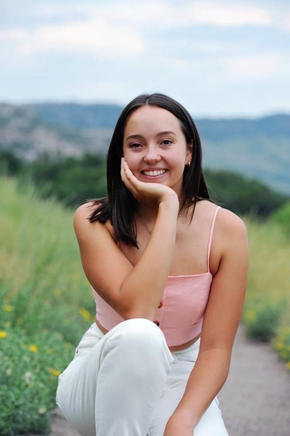 Sophia Meza smiling for the camera during her Senior Sunday photoshoot in the beautiful outdoors. 