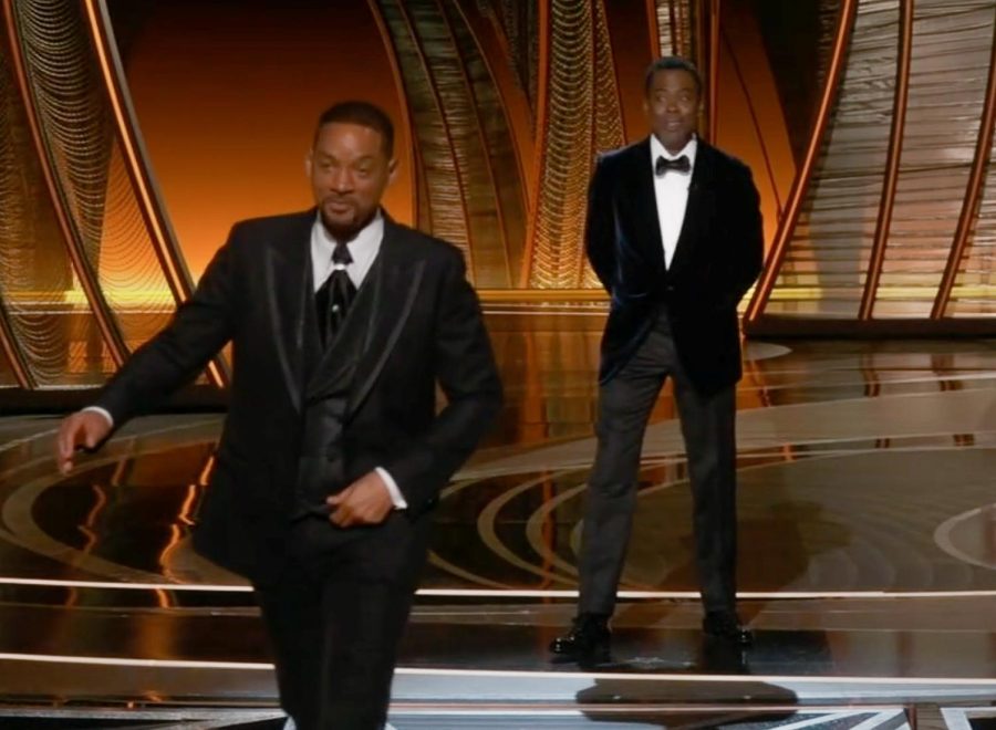 Will Smith walks away from a smiling and preening Chris Rock just moments after he assaulted the man on live television. The event has caused an uproar not just in Hollywood but all over the nation over whos to blame for the situation. The debate and its importance to so many people, including those in our community, shows how society is still working on how to handle people who both verbally and physically attack others.