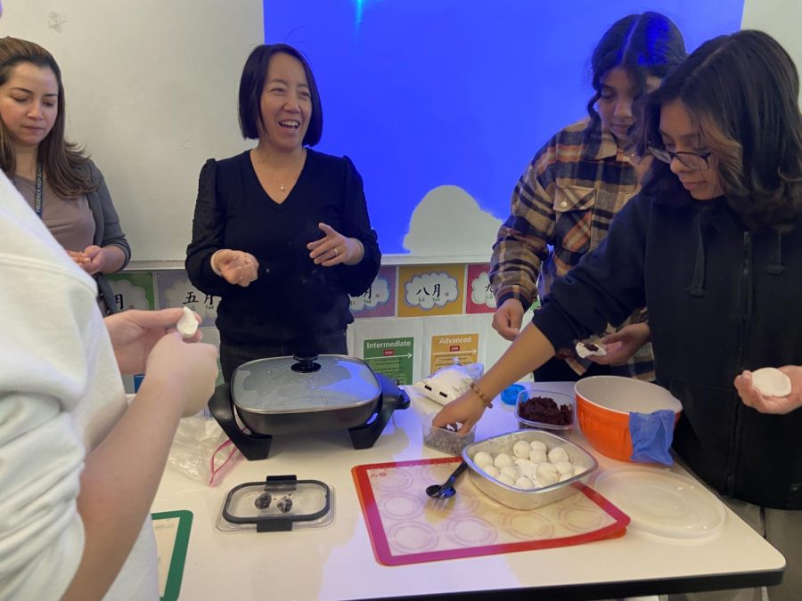 Ms.Sheng teaching the class how to make rice balls in celebration for Chinese New Years