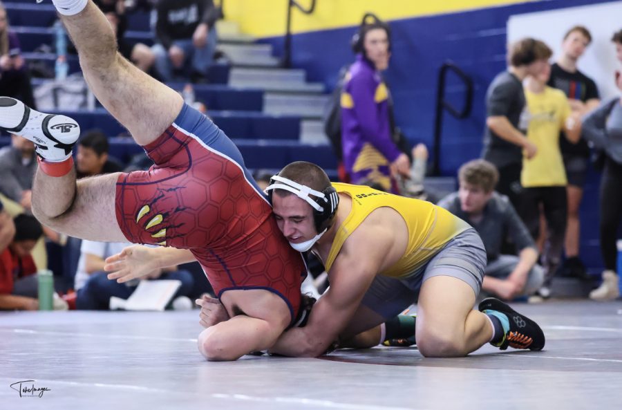 Sophomore Diego Rangel attempts to pin an opponent from Northridge High School at the first ever Golden Eagle Invitational Tournament. In this tournament Diego brought a gold medal back to the team in the 150 weight class. 