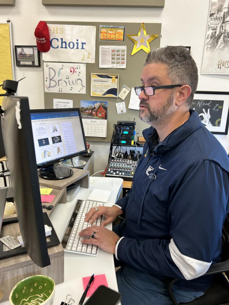 A photo of Mr. Brown doing important things at his desk.