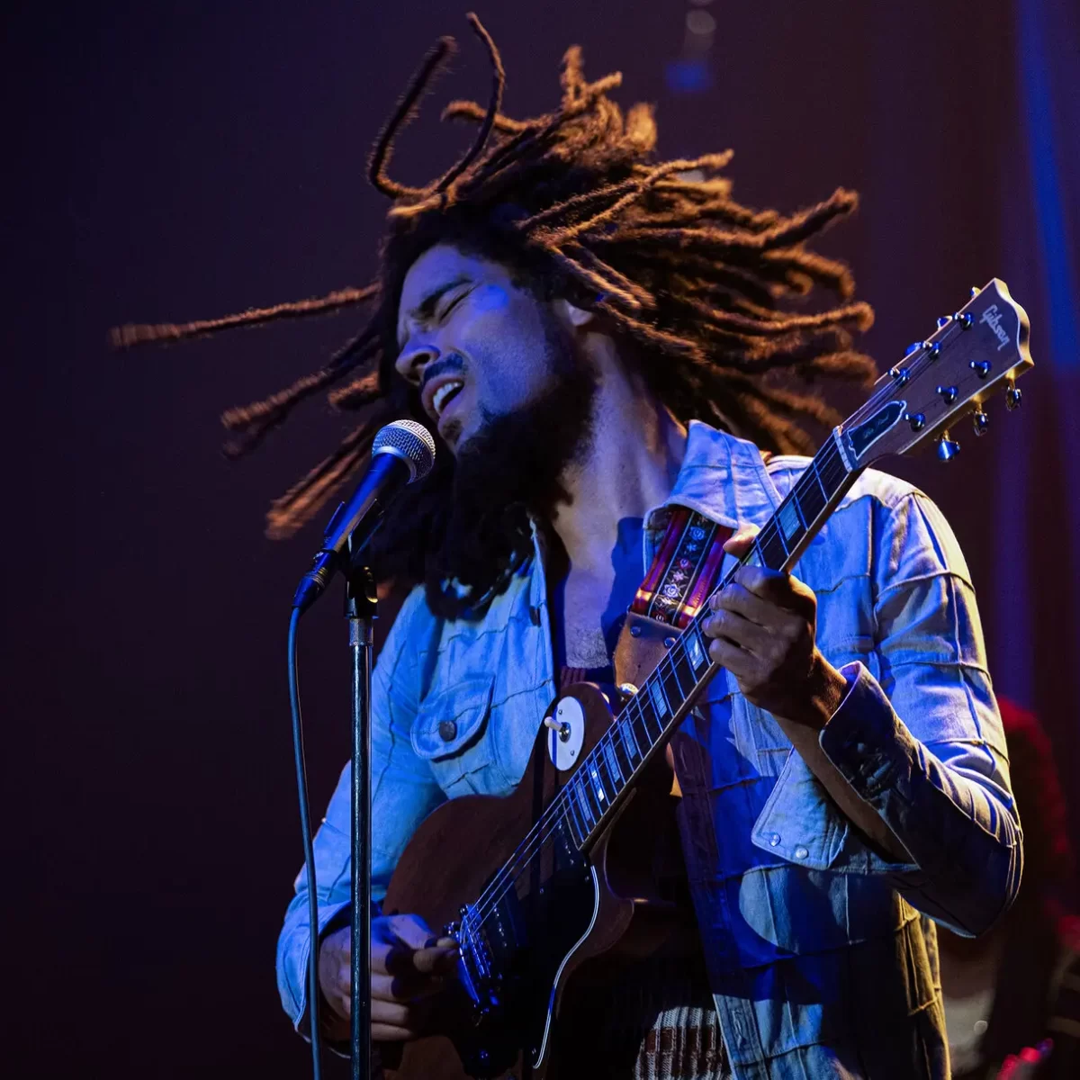 Bob Marley (Kingsley Ben-Adir) singing a song filled with message on stage after his popular album release Exodus. The film Bob Marley: One Love is currently ranked #1 in America since its release on Feb. 14 as it reveals the true message behind his legendary music.