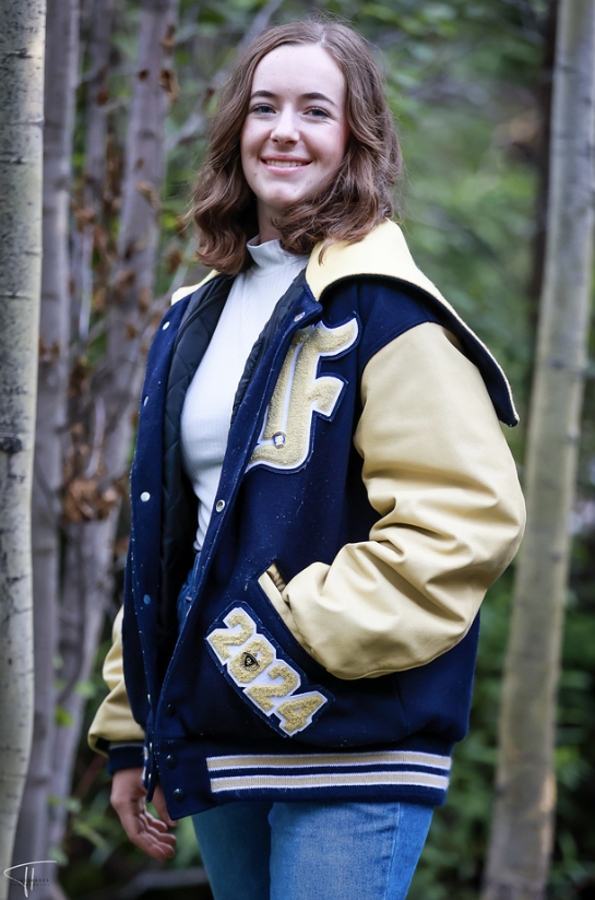 Isabel wears her letterman jacket while posing for her senior photos.