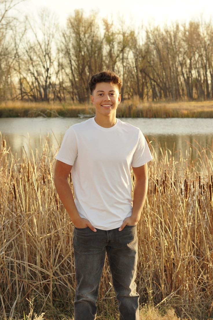 Senior Matthew Sais smiles at the camera during his senior photos in the great outdoors. Matthew is a leader and inspiration to all as he is filled with passion and enthusiasm.