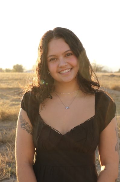 Kaya Paluda smiles at the camera during her senior photos in the wonderful outdoors. Kaya’s warm smile welcomes all who encounter her. The kind hearted student-athlete is setting a new standard of excellence in every aspect of life.