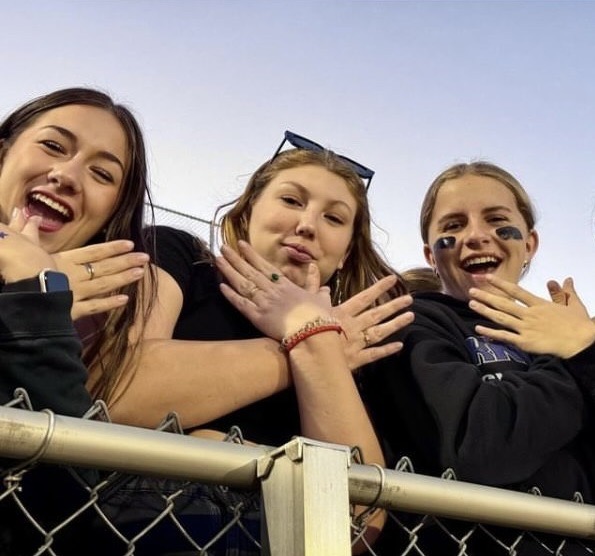 Adriana Carnicero Santiago, Carmen Casino Blazquez, both exchange students from Spain, and Brinley Weingardt at the first home football game of the year. 