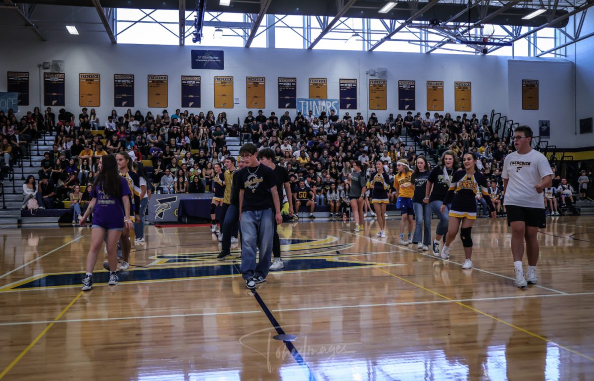 The Varsity Blue choir singing and performing during the 2024 homecoming assembly. 