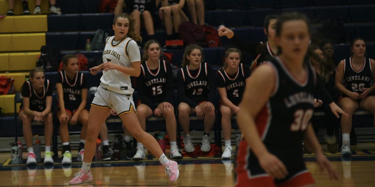 Ready to receive. Izzy Howard, sophomore, reaches the end of the court, positioning herself just outside the 3 point line. Throughout the night, Izzy made a majority of her shots, helping the team finish on top. 