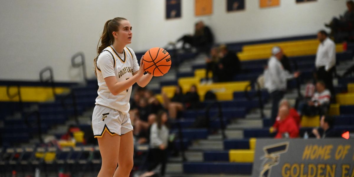 Izzy Howard, sophomore, takes a shot from the free point line during the second half. Izzy said that she “thought we played well as a team, but we definitely have a lot of work to do.” 