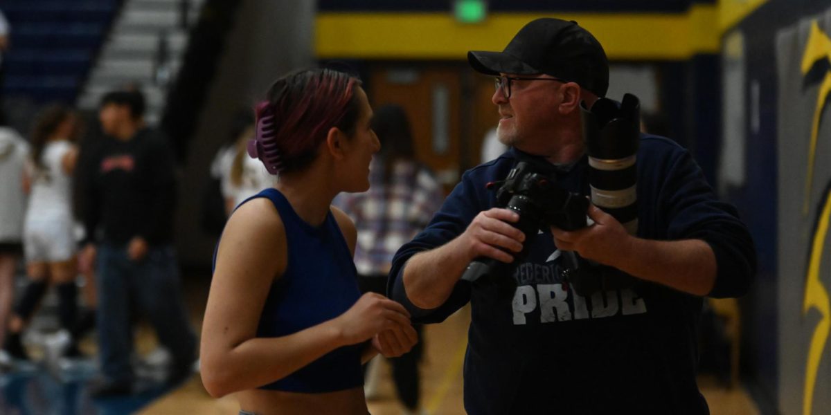 Always behind the camera, but never in front. Chris Tone is a valued Frederick photographer that never fails to make it to FHS sporting events, supporting the school in all the ways he can. Next to him is Jenna Johnston, junior, who is a member of the yearbook staff. Jenna told the Lantern how, “taking photos for Frederick is such a fun and exciting experience. I enjoy getting to support all the sports [that] I love while also capturing memories for all of our athletes.” 