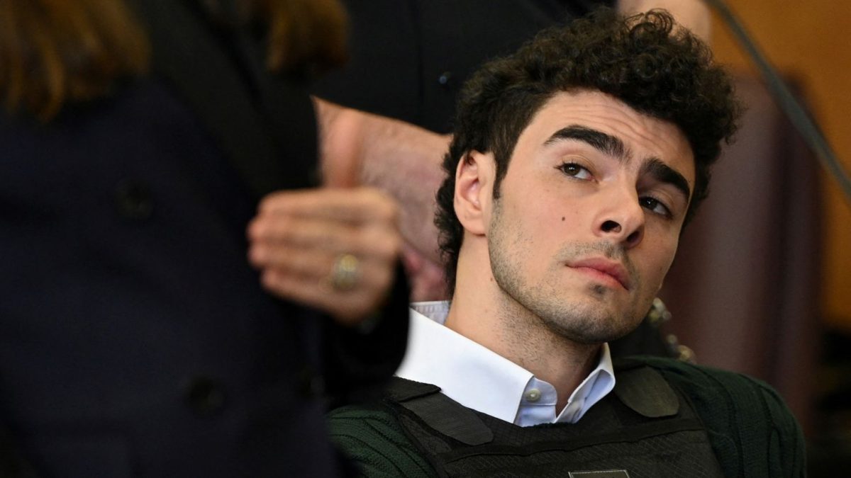 Luigi Mangione sitting in court, patiently awaiting to see of the court rules if guilty or not guilty.