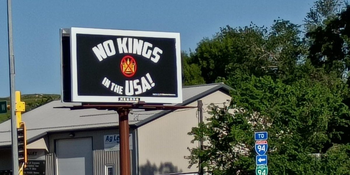 A billboard reading "No Kings in the USA!" stands above a car dealership in the small town of Valley City, North Dakota (population 6,580) on June 21, 2025. The No Kings protest, which became the largest protest in US history, saw major turnout in big cities, but even small rural towns across the country saw their citizens turn out