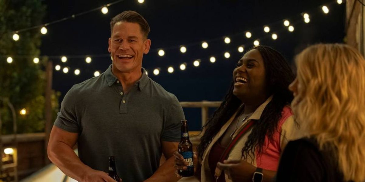 Christopher Smith, AKA Peacemaker (John Cena) celebrates a reuinon with his friends Leota Adebayo (Danielle Brooks) and Emilia Harcourt (Jennifer Holland). Season Two picks up a year after Season One, and while the episodes are on average shorter, the series still packs a lot of action and comedy. (Erin Sintoes/HBO Max)